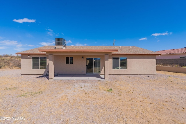 back of house featuring a patio area, fence, central AC, and stucco siding