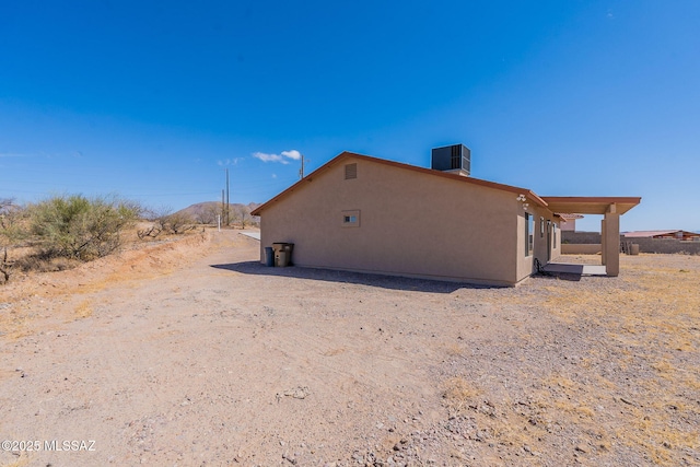 view of home's exterior featuring central AC and stucco siding