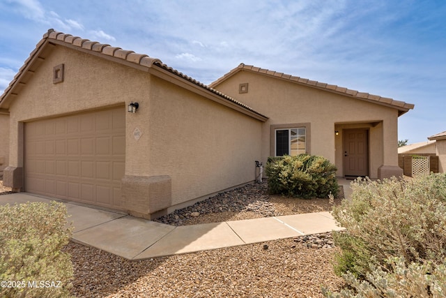 mediterranean / spanish-style home with stucco siding and a garage