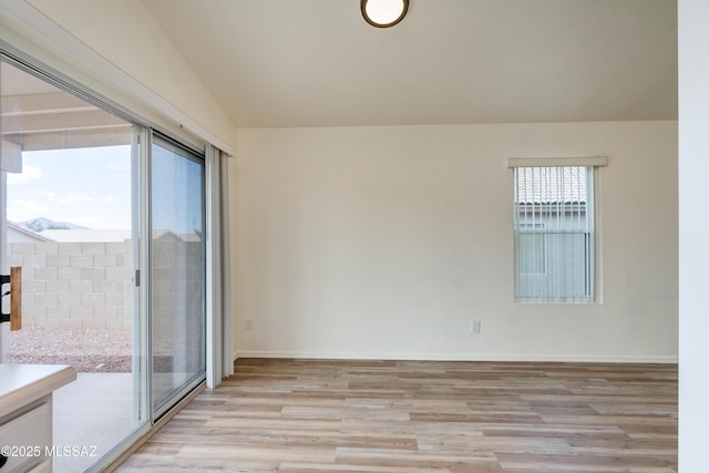 unfurnished room featuring light wood-type flooring and baseboards