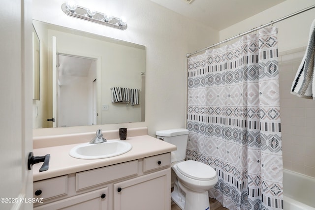 bathroom featuring shower / tub combo, toilet, and vanity