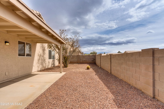 view of yard featuring a patio area and a fenced backyard