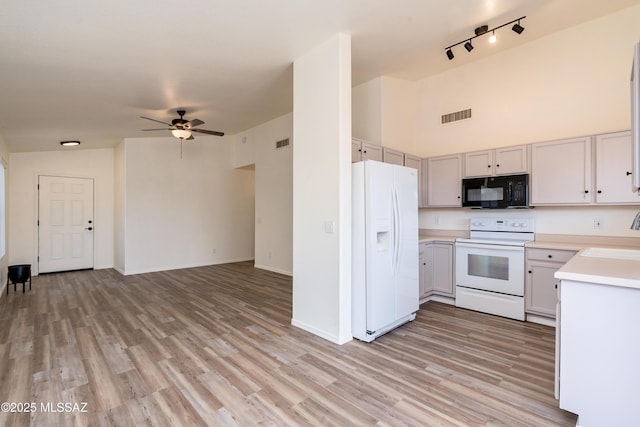 kitchen with white appliances, open floor plan, light countertops, and visible vents