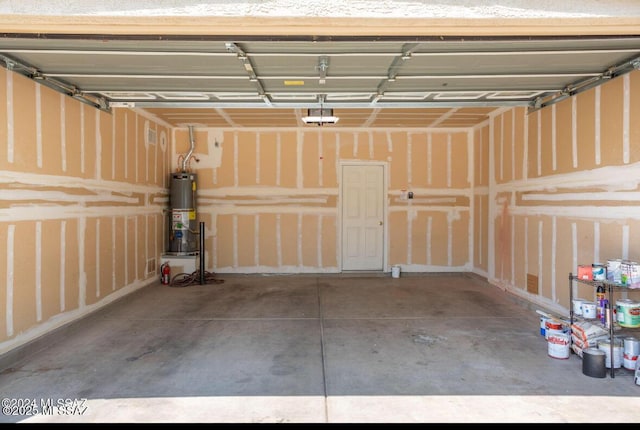 garage featuring a garage door opener and water heater