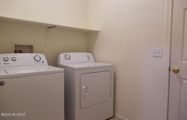 laundry area featuring laundry area, washer and clothes dryer, and baseboards