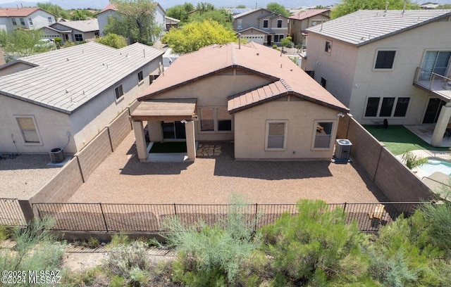 back of property with a fenced backyard, a patio, and stucco siding