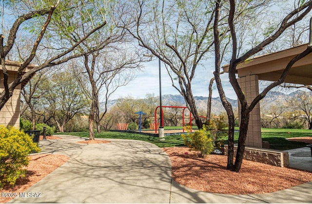 view of home's community with playground community and a mountain view