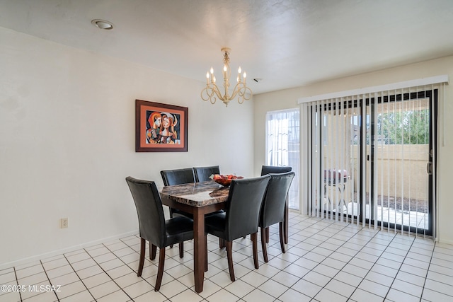 dining space featuring light tile patterned floors, a chandelier, and baseboards