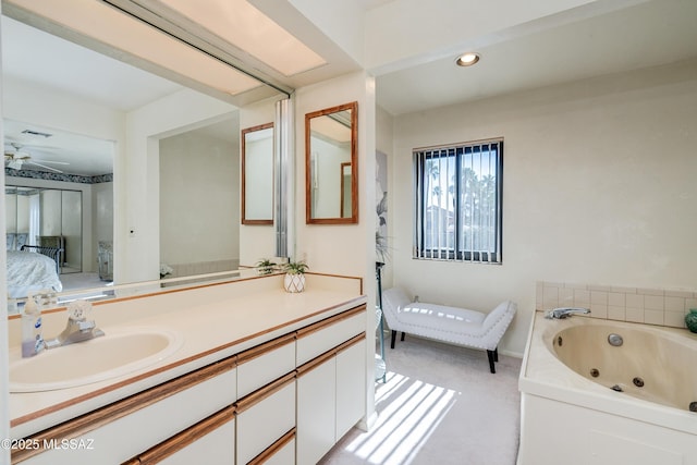 full bath with recessed lighting, vanity, a whirlpool tub, and ensuite bathroom