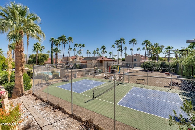 view of tennis court with fence