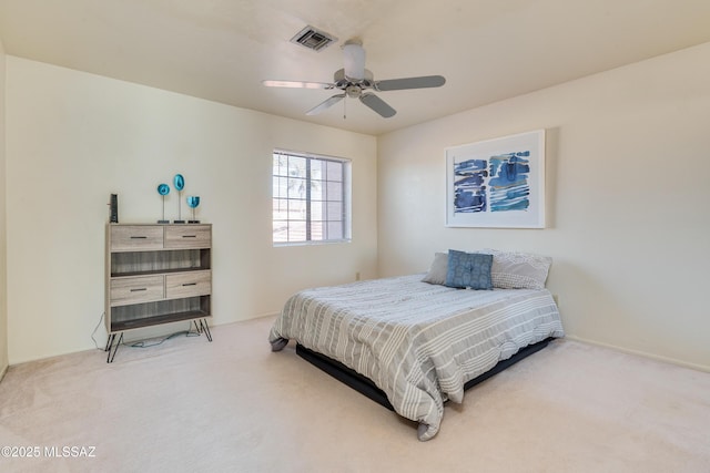 carpeted bedroom with baseboards, visible vents, and a ceiling fan