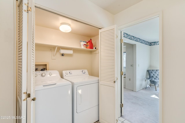 washroom with washer and dryer, laundry area, and light colored carpet