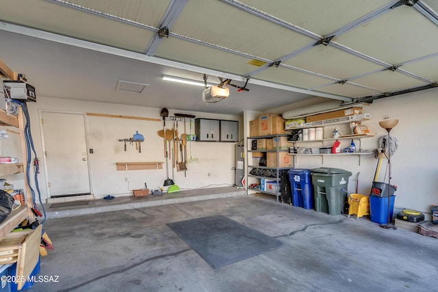 garage with water heater and a garage door opener