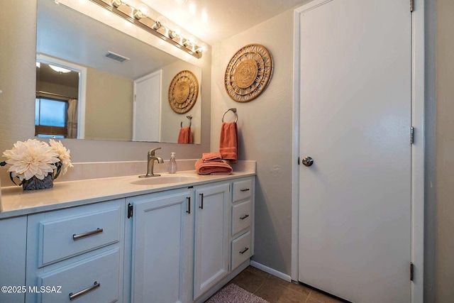 bathroom with tile patterned floors, visible vents, and vanity