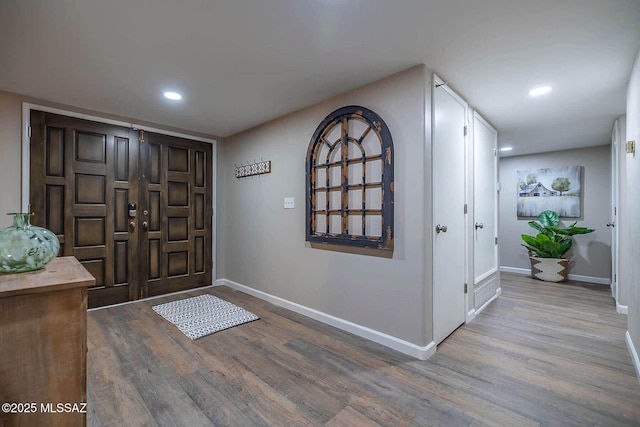 entryway with recessed lighting, wood finished floors, and baseboards