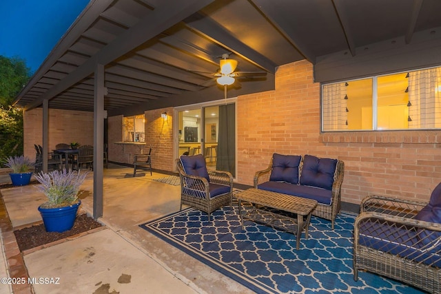 view of patio with a ceiling fan and an outdoor living space