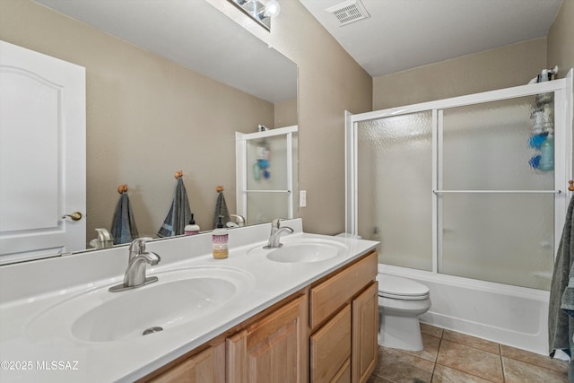 full bathroom with double vanity, visible vents, a sink, and tile patterned floors