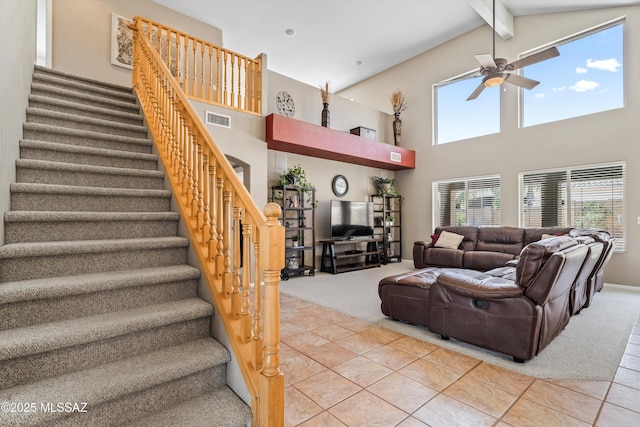 living room with light tile patterned floors, visible vents, light carpet, beamed ceiling, and stairs