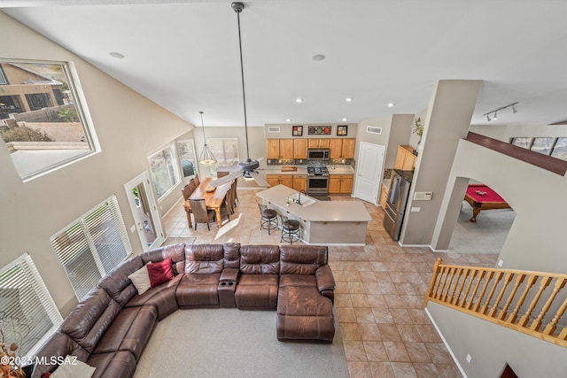 living area with lofted ceiling, baseboards, track lighting, and recessed lighting