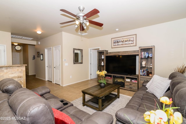 tiled living room featuring a ceiling fan, visible vents, and baseboards