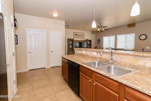 kitchen featuring black dishwasher, brown cabinets, light countertops, hanging light fixtures, and a sink