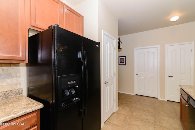 kitchen featuring decorative backsplash, baseboards, black appliances, and light tile patterned floors