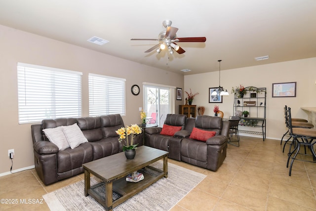 living room with light tile patterned floors, ceiling fan, and visible vents