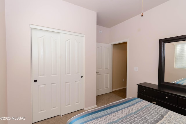 bedroom featuring a closet, baseboards, and carpet flooring