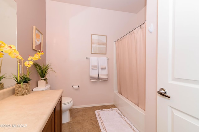 bathroom with tile patterned flooring, toilet, vanity, baseboards, and shower / bath combo with shower curtain