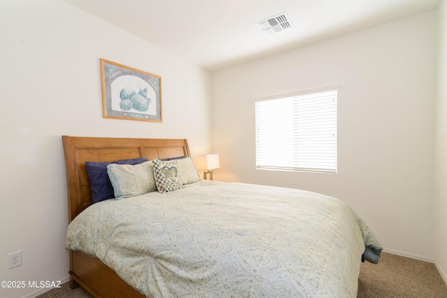 carpeted bedroom with visible vents and baseboards