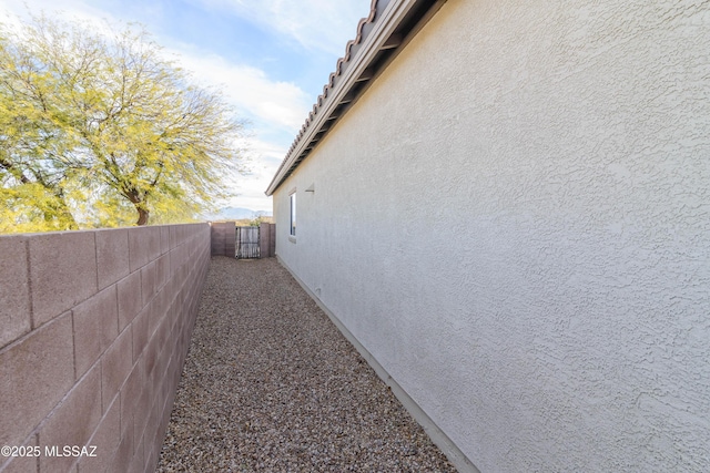 view of property exterior with fence and stucco siding