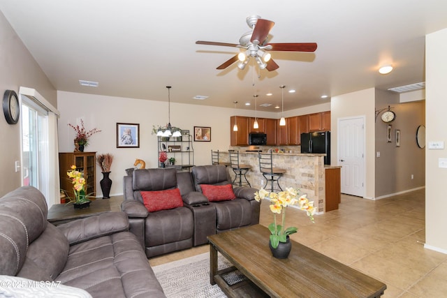 living area with recessed lighting, visible vents, ceiling fan, and baseboards