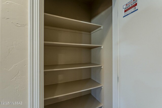 garage featuring a garage door opener, water heater, and baseboards