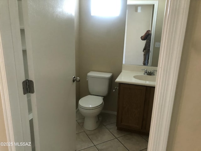 bathroom with vanity, tile patterned flooring, toilet, and baseboards