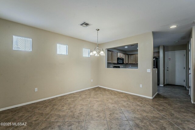 view of front of house with an attached garage, fence, a tile roof, driveway, and stucco siding