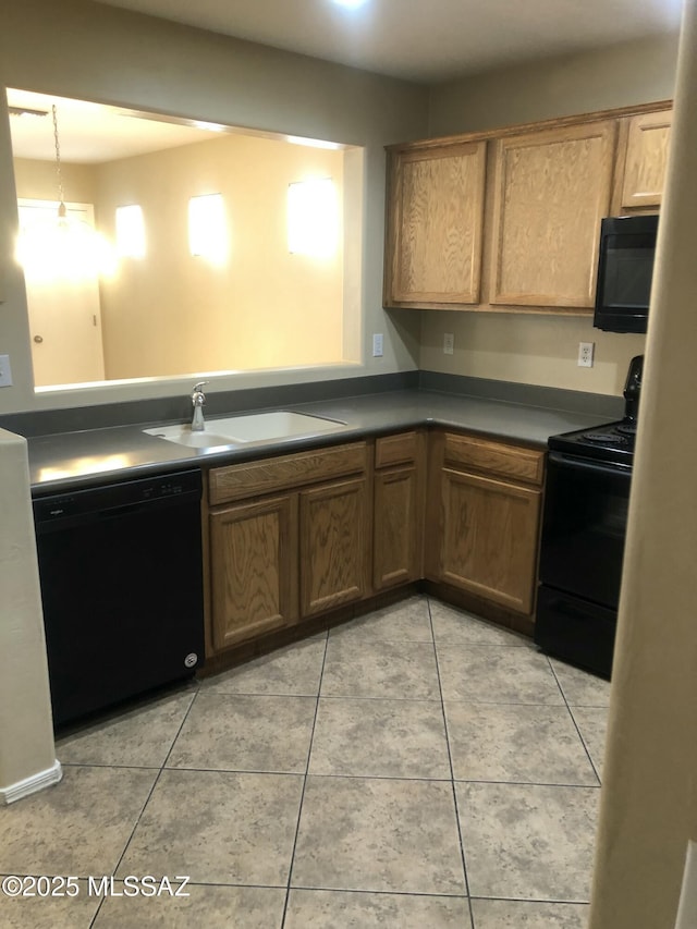 kitchen with black appliances, dark countertops, a sink, and light tile patterned flooring