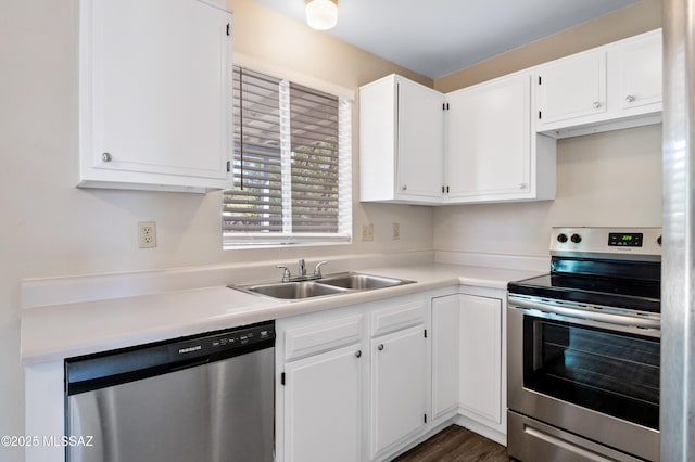 kitchen featuring stainless steel appliances, white cabinets, and a sink