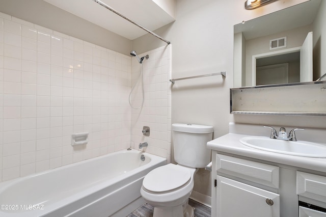 full bathroom featuring visible vents, vanity, toilet, and bathing tub / shower combination