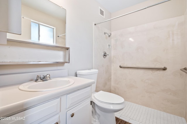 bathroom featuring toilet, visible vents, a shower, and vanity