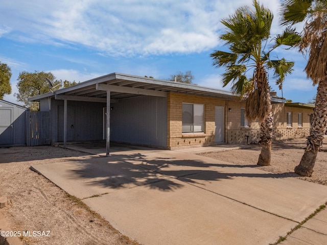 view of front of house featuring driveway and an attached carport