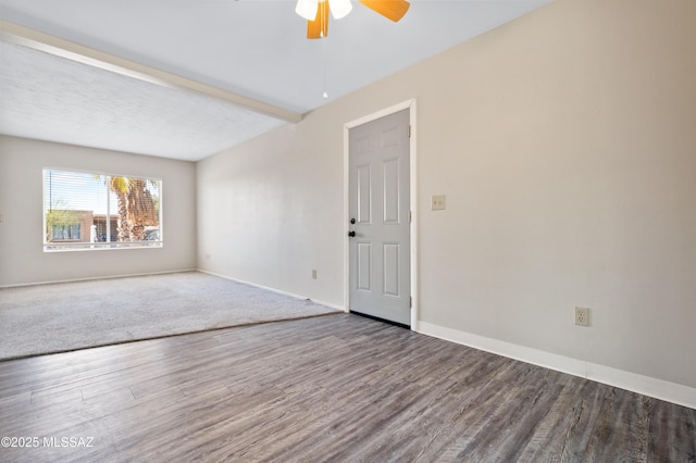 spare room featuring ceiling fan, beamed ceiling, baseboards, and wood finished floors