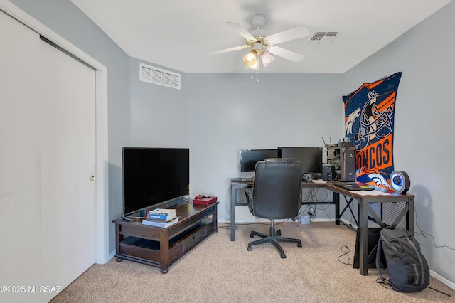 carpeted office featuring ceiling fan, visible vents, and baseboards