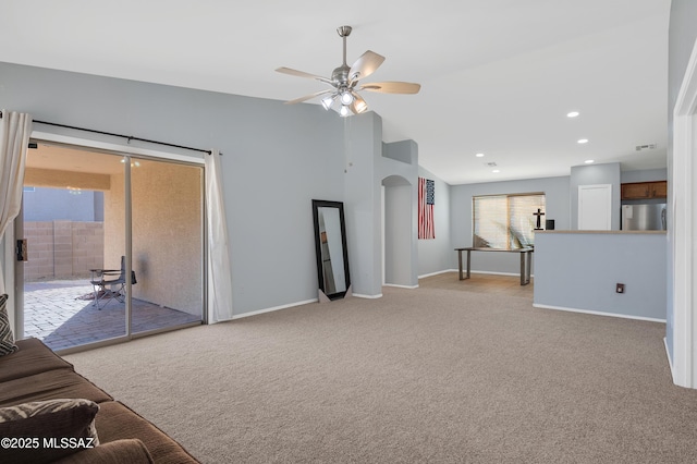 unfurnished living room with baseboards, light colored carpet, lofted ceiling, ceiling fan, and recessed lighting