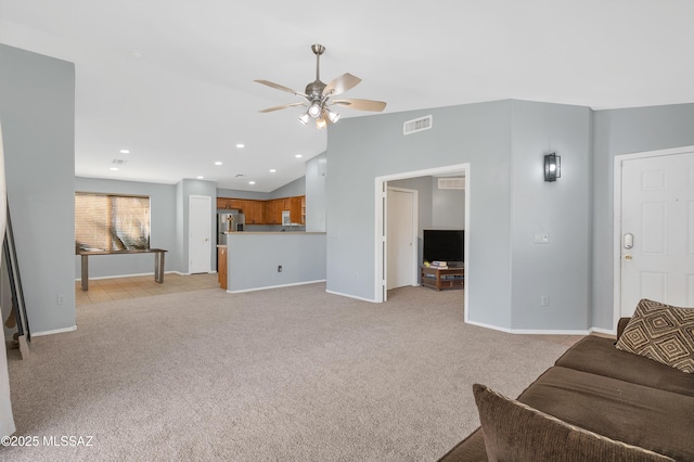 living area with a ceiling fan, lofted ceiling, visible vents, and light carpet