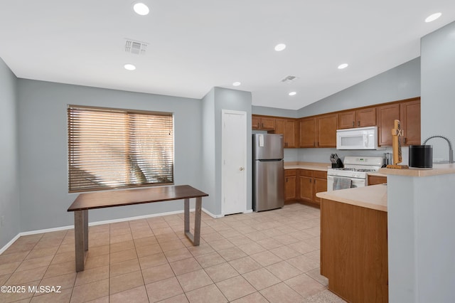 kitchen with light tile patterned flooring, white appliances, visible vents, vaulted ceiling, and light countertops