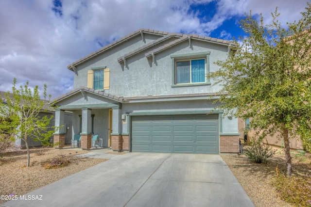 craftsman house featuring a garage, concrete driveway, a tiled roof, and stucco siding