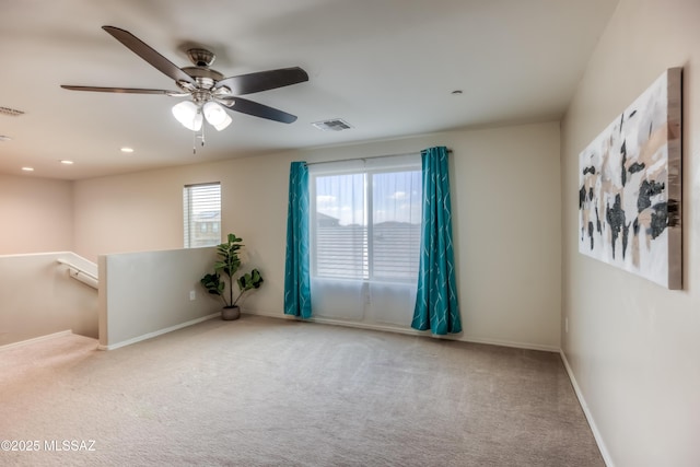 empty room featuring carpet, visible vents, baseboards, and recessed lighting