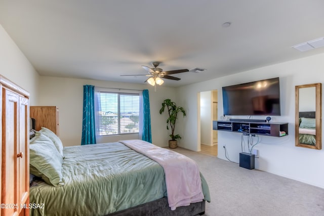 bedroom with carpet floors, visible vents, and a ceiling fan