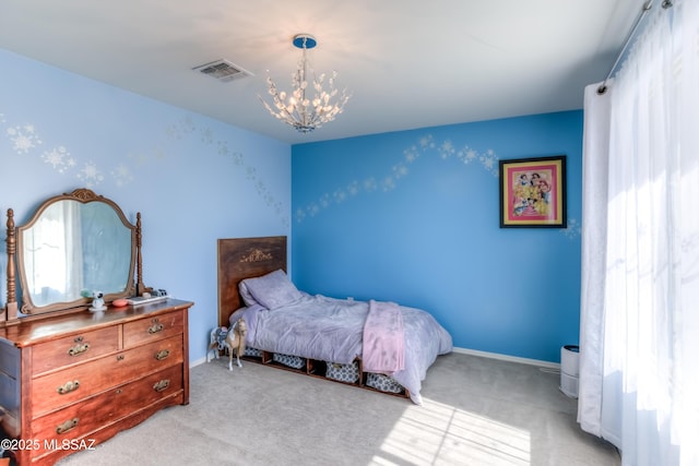 bedroom with baseboards, light colored carpet, visible vents, and an inviting chandelier