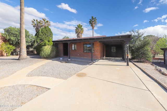 ranch-style home with a carport and driveway